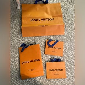 4 Louis Vuitton shopping bags